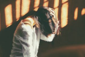 woman holding her head, Persistent Vomiting